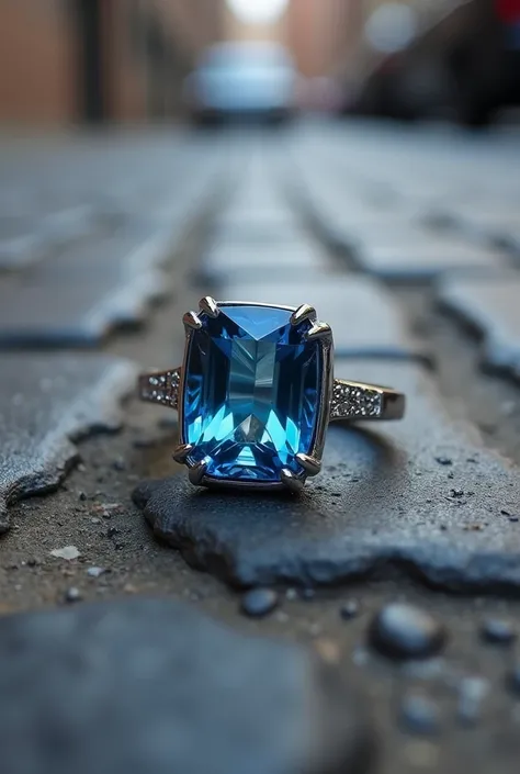 A close-up of a ring with a blue stone in the street 