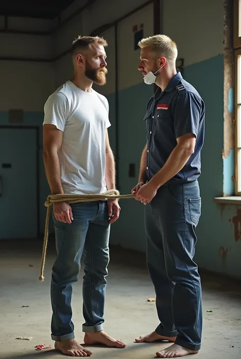 A Nordic man with a short beard and hair dressed in a white t-shirt and jeans without shoes or socks is sitting tied hands and feet on his back with thin rope and ribbon around his mouth in an abandoned factory. He is tied by a blond Finnish man who dresse...