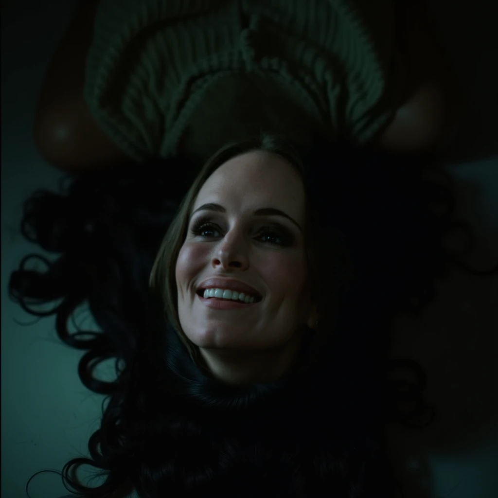 Closeup cinematic still frame captured from above of 35 year old madeline stowe with a blank expression and glowing red eyes, lying on her back face up on the floor of a dimly lit hotel room with a trickle of blood on her forehead, long dark hair dimples, ...