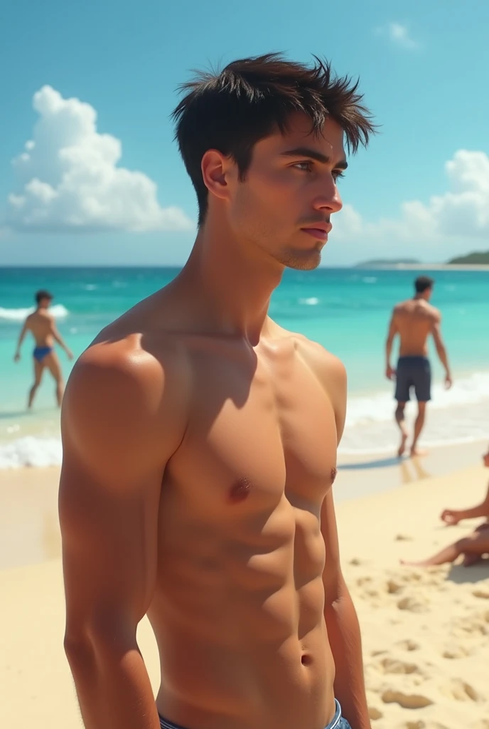 The image shows a young man standing on a beach. He is shirtless and appears to be in his late twenties or early thirties. He has short dark hair and is looking off to the side with a serious expression on his face. In the background, there are other peopl...