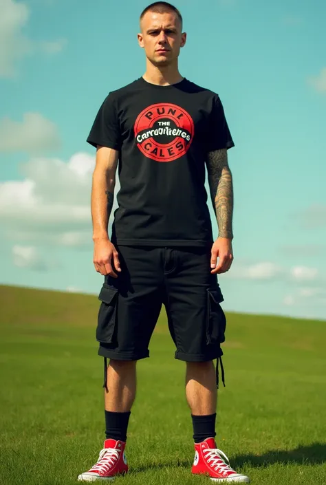 30 year old england man with buzzcut hair style, wearing a black t-shirt with a picture of the band The Casualties, wearing black cargo shorts, wearing red Converse shoes, posing standing on green grass, colored tones.