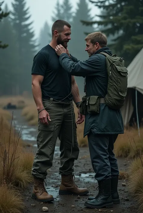 A nordic man with a short beard and hair dressing hiking boots, cargo pants and black t-shirt is tied up from his legs and hands with thin rope in a survival camp, getting gagged with a wide tape by finnish man dressing black army boots. 