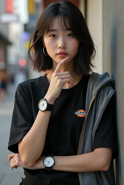 Daniel Wellington wears a watch and a black Dickies t-shirt, headshot of a Japanese woman standing facing the front, wearing an outerwear hoodie