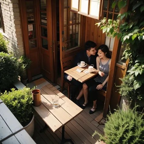 A young couple at coffee shop window, view from outdoor above. Some leave outdoor, sun light hit on and off on leaves.