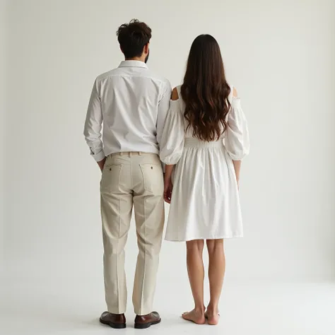 Man and woman dressed in white with their backs to each other posing for photos facing me