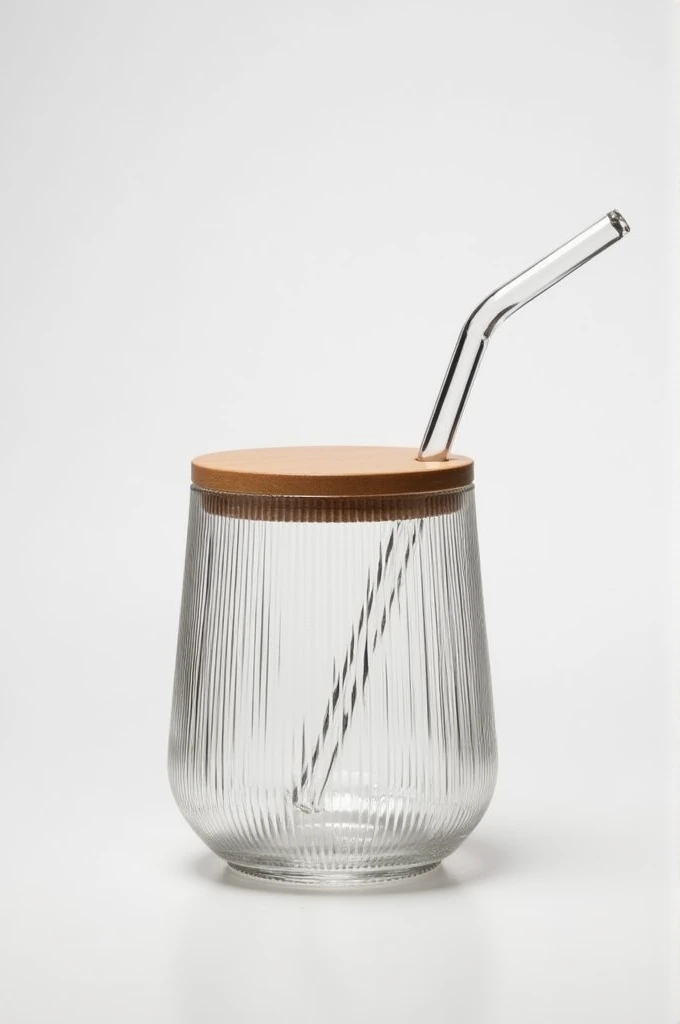 A tumbler shaped ribbed glass with flat wooden lid and glass straw