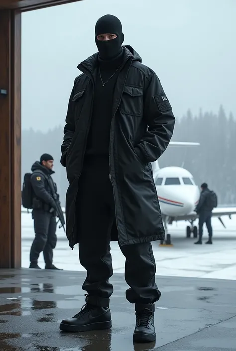 A man on the terrace in black pants, black jacket, air force 1 negros , sexy, manly,
 and balaclavas negrs, winter. Safe house. Prive plane, armed bodyguards behind him 
 

