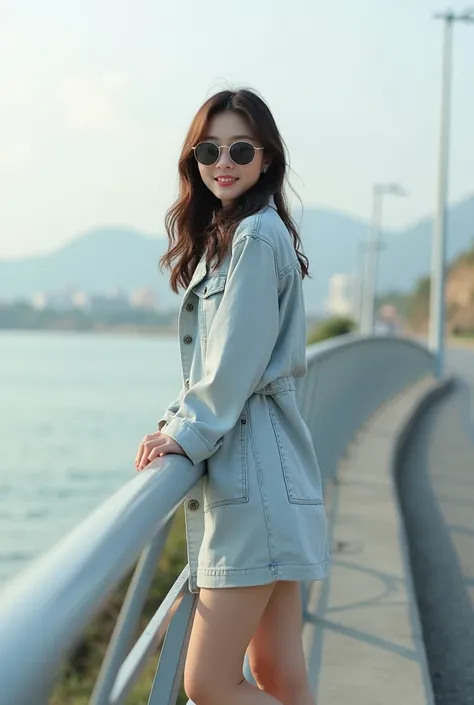 Beautiful Korean woman wears jeans material dress ash color sneakers,  Sunglasses , standing full body on the edge of the sea leaning on the bridge while facing the camera soft smile and cute background of the bridge atmosphere in the morning .ultra HD, re...