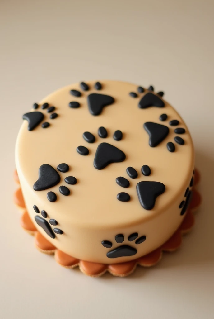 A light brown round masapan ,  cake with black dog prints all over it
