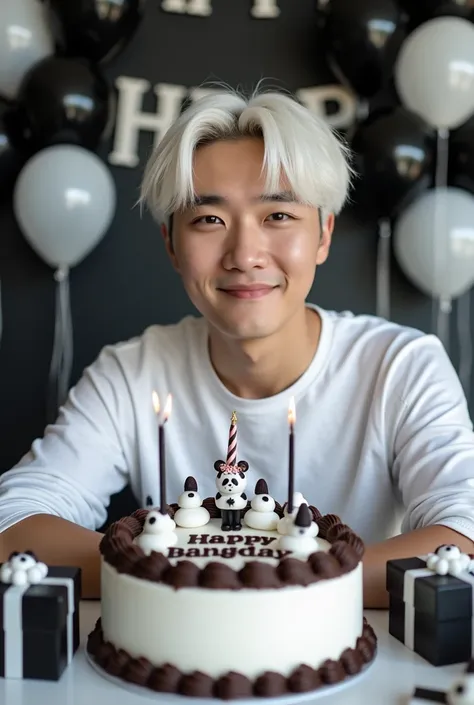 A photo of a handsome young korean man, white hair, beared less face, celebrating birthday, black n white decoration theme, white and chocolate cake with the words "HAPPY BIRTHDAY BANGMIN", the back wall is decorated with panda balloons, there are several ...