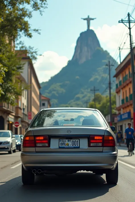 take a picture of a gray mazda 323f from 1995 on Moldovan idd001 numbers driving through Brazil in front of the statue of Jesus Christ