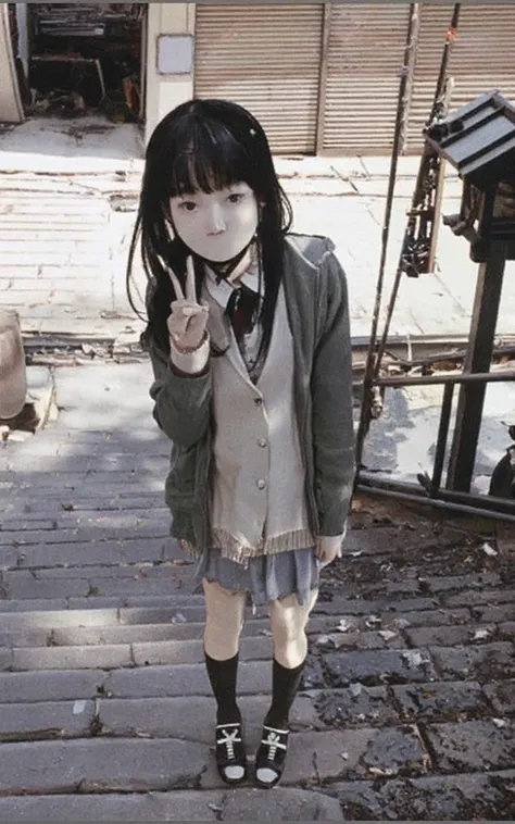 A teenage girl, with straight black hair, bangs, Japanese, and pale skin