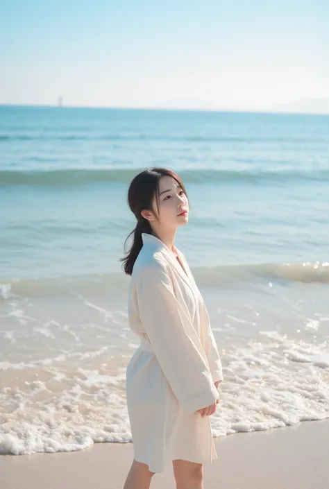 young asian girl standing facing sea at beach shore 