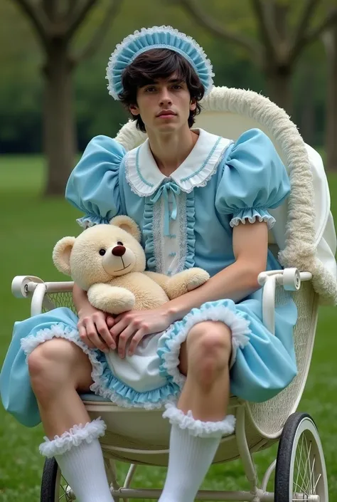 Real photo. An adult  male 20 years old handsome dark wavy hair wears blue ruffled dress with puffy sleeves, large Peter Pan collar, big diaper, bonnet, white frilly kneesocks, hugging teddy bear. He sits strapped on a frilly victorian pram in the park. 