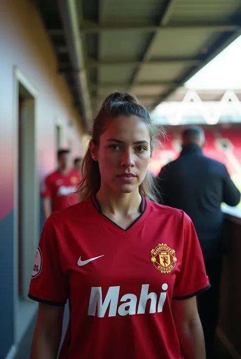 Manchester united player, name mahi she seen in back way in stadium to the camera and player name writes in uniform