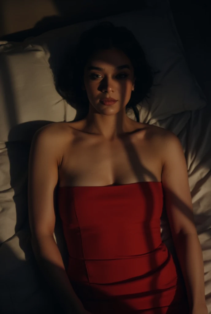 Hailee Steinfeld, picture from above, lying  limp on a bed, red strapless dress, black bob cut hair