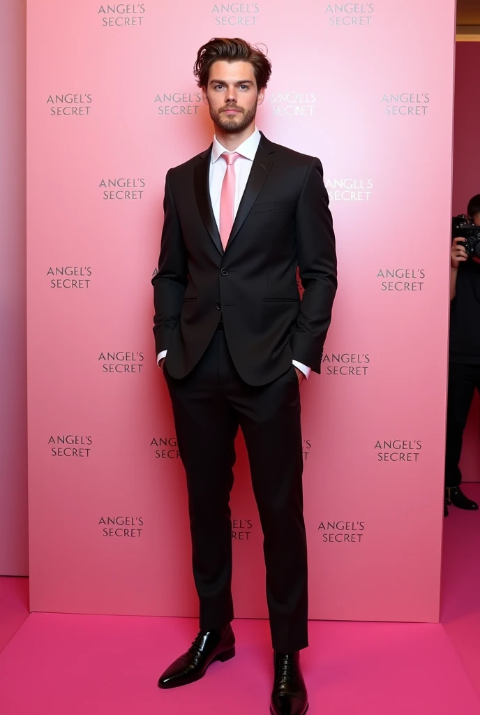 all body view of a strong man, noah centineo, 19 years old, light brown short wavy hair, brown eyes, with a beard, very sharp well defined jawline, wearing a black luxury and elegant suit with a pink tie, standing infront of a light pink/pink wall with rep...