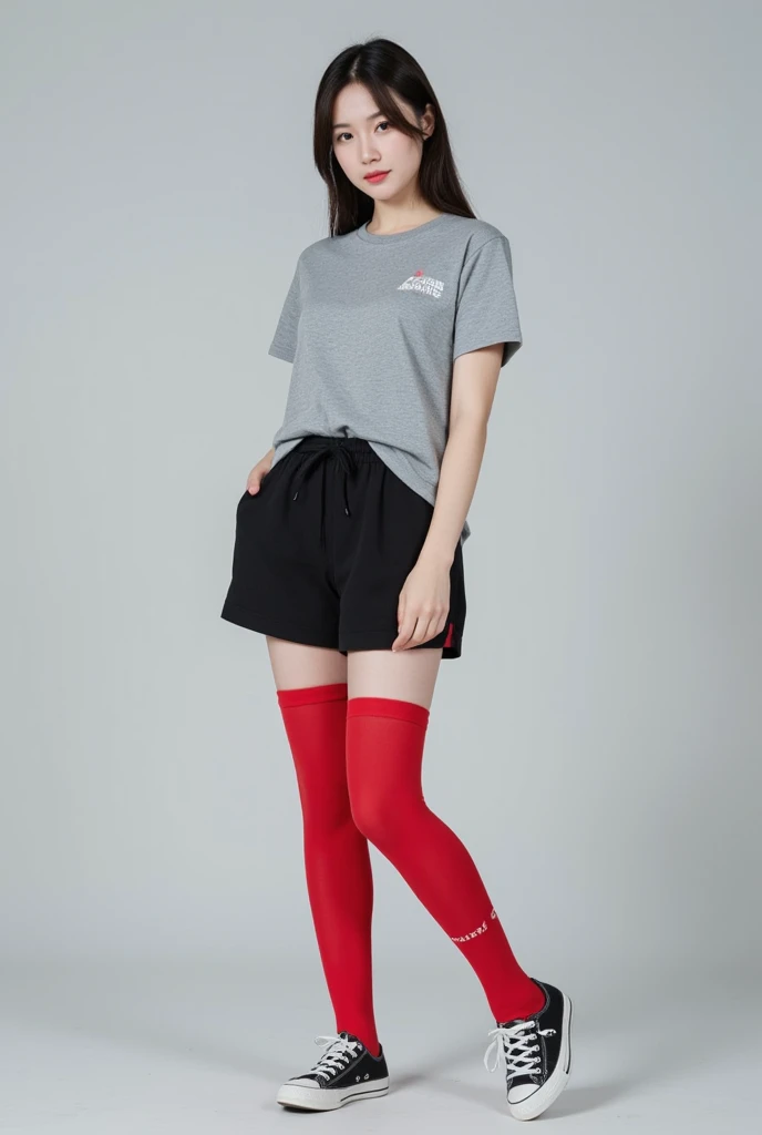 A girl wearing a gray shirt, black shorts, red high thigh socks and converse