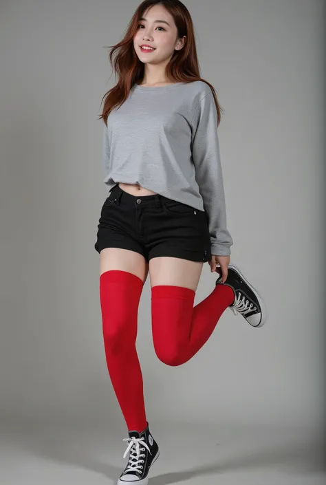 A girl wearing a gray shirt, black shorts, red stockings and converse