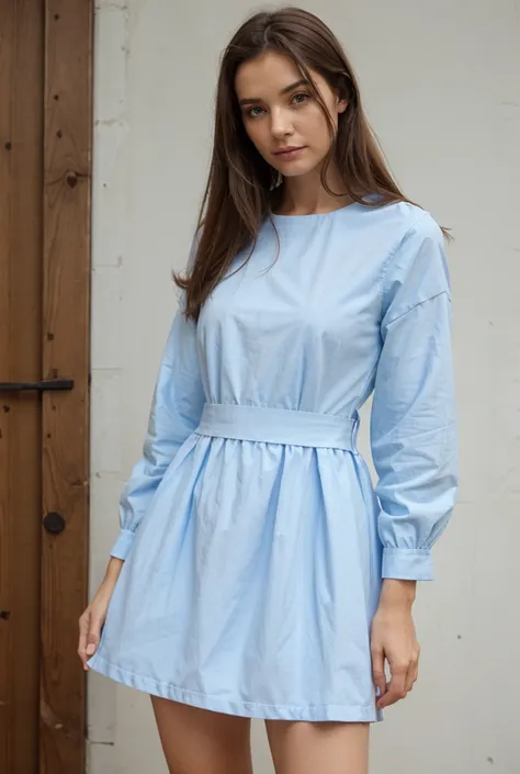   Woman wearing a dress with long sleeves in bright blue, in cotton fabric  ,   with a simple and elegant cut   