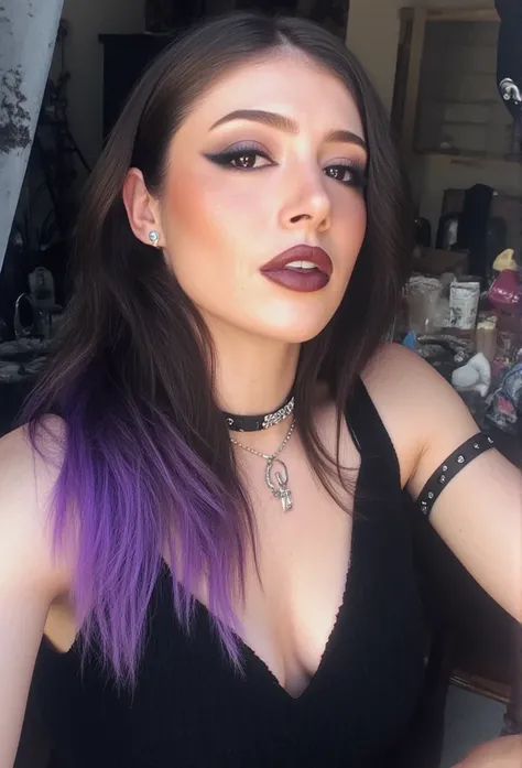 43stet1c The image shows chrissy taking a selfie, styled in a gothic fashion. Her hair is a mix of black and purple, with the colors blending in streaks or sections. She is wearing various pieces of jewelry, such as rings, necklaces, or bracelets, but nota...