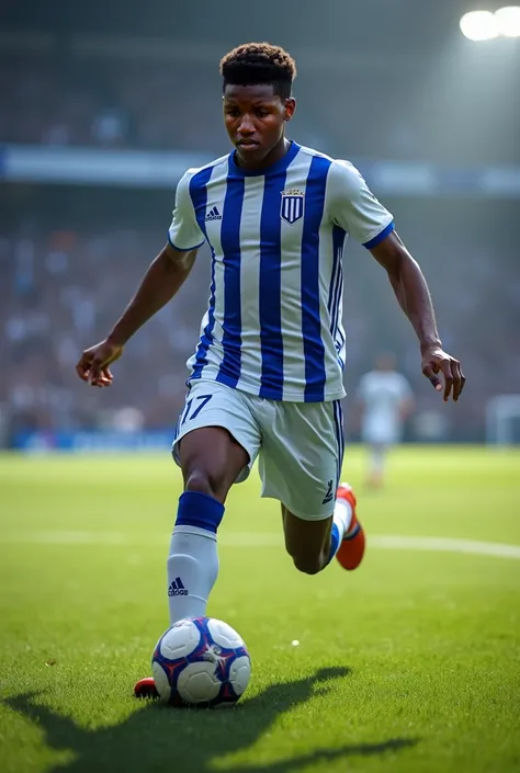 A black teenager with number 17 ,  and named Daniel in the back hitting a free kick with a soccer kit with blue and white stripes