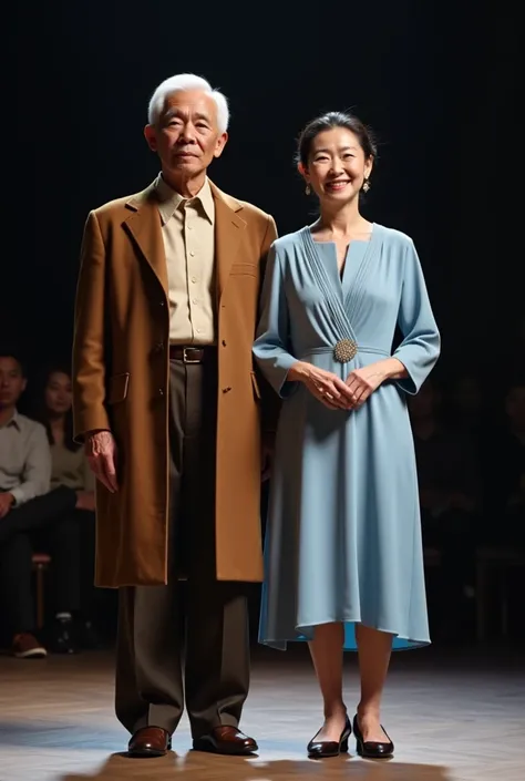  An elderly Asian couple on the lunatic stage of Americas Got
Talent captured in a dramatic and elegant moment.  The man is wearing a long brown overcoat with a formal beige shirt underneath ,  combined with dark brown pants and simple, polished shoes .  H...