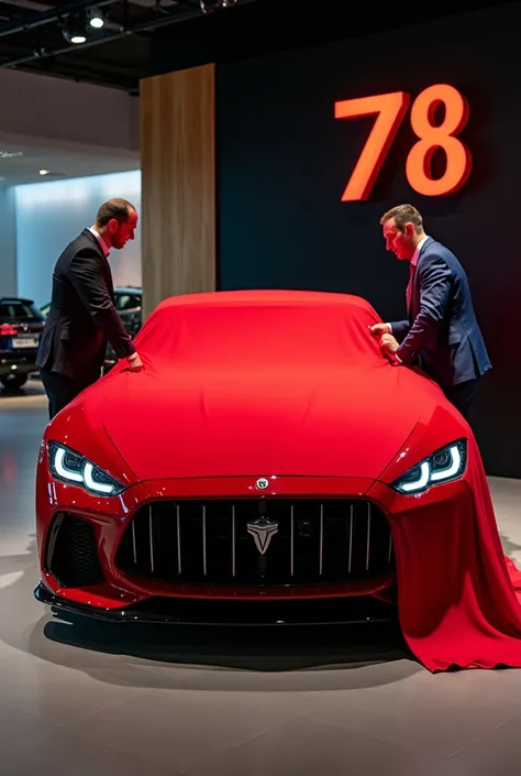 A 2025 ( scania 770s v8) in a luxurious showroom. A man and a woman are in the process of unveiling the car by pulling off a red cloth that covers it, revealing the cars sleek design. The car itself is a striking red, with polished details reflecting the h...