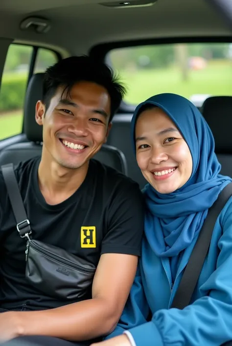 The image shows a man and a woman sitting in a car with green garden. The man 20 agged is on the left side of the image, wearing a black t-shirt with a yellow logo on it and a black fanny pack around his neck. He has short black hair and is smiling at the ...