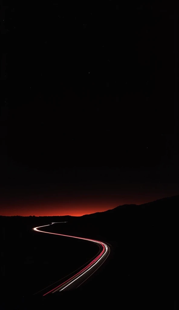 A winding two-lane highway at night is depicted, with light trails from passing vehicles creating streaks of white and red light.  The road curves gently through a dark landscape. The sky is a deep, almost black, with a reddish-orange/brown band along the ...