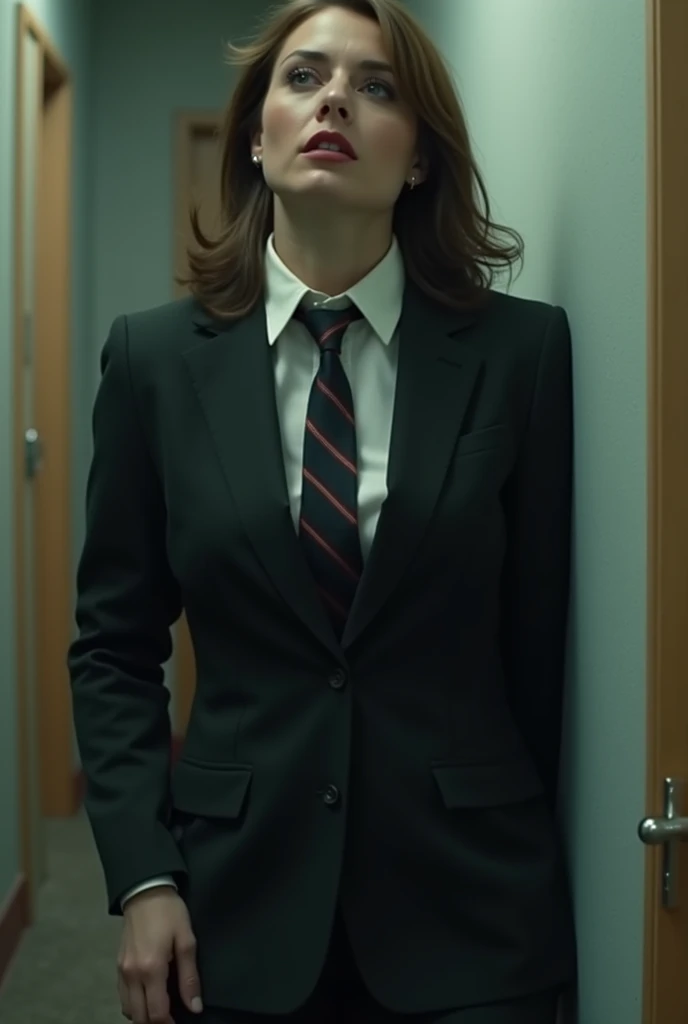 Create me a video of a woman in a suit and tie stabbed and falling to the floor