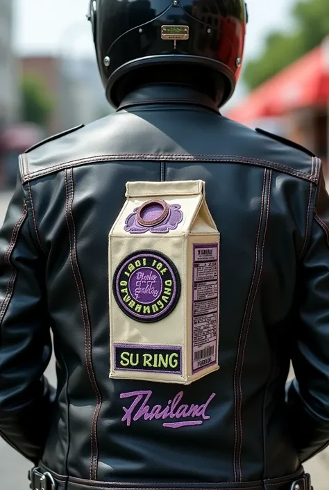 Behind the leather jackets of a group of motorcycle lovers It has a symbol similar to a milk carton. with the name embroidered on the back of the milk carton saying "Su Ring" and on the bottom of the milk carton "Thailand" It has a purple and green logo.