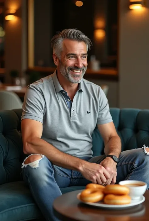 elegant mature man 40 with a haircut appropriate to his age with few gray hair in a luxury coffee shop,  dressed in distressed denim pants and a Nike polo t-shirt, relaxed on a comfortable sofa ,  with a bowl of handmade coffee and a plate of fresh, golden...