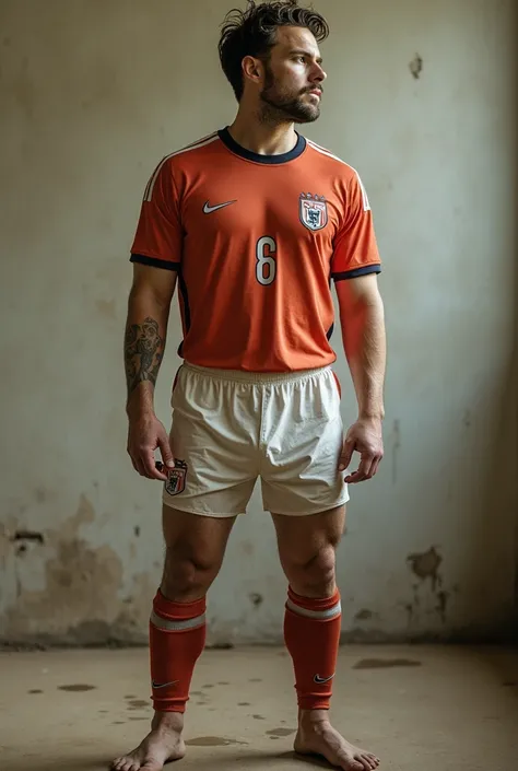 Soccer player wearing a soccer shirt showing his navel with semen with hair only dressed in the t-shirt and some old briefs that are thin almost transparent, stained with urine and marking his penis and testicles, showing his feet 