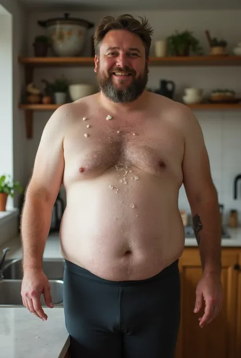      An attractive heavy overweight very fat man in his 50s is in his kitchen and is wearing no shirt but very tight cyclist pants .  He makes a happy face    . Very few , Very small, flat droplets of moist ,  fresh milk are on his stomach .   The countert...