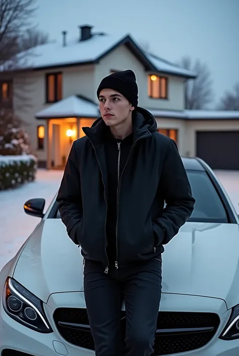 a young guy of Slavic appearance twenty-five years old dressed in a black cap black jacket and black jeans leaning on the hood of a white Mercedes car which is fully visible on the background of a two storey expensive house on the street winter and evening