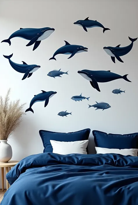 A bedroom with navy blue bedding and on the walls there are paintings and wall stickers of sea animals but only navy blue and white 