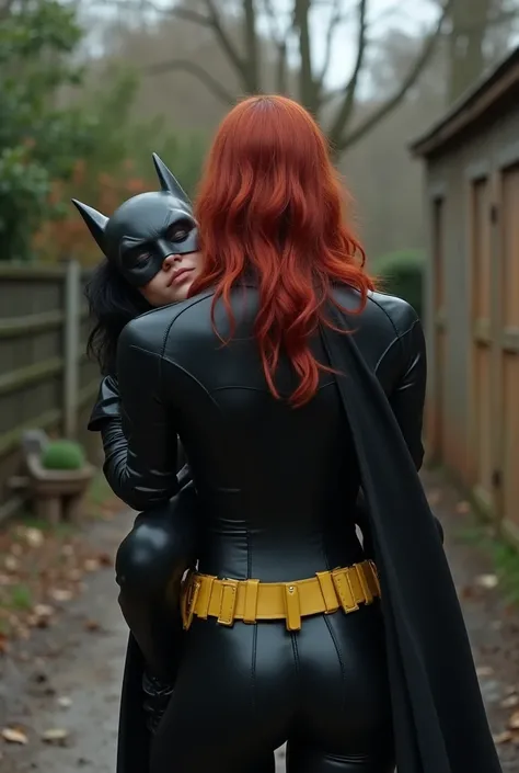 Realistic, rear ass view of a 50 yr old milf carried over the shoulder of a teenage girl with red hair, milf is passed out unconscious and sleeping with black hair and a black leather batgirl mask laying on her stomach on the ground eyes closed, milf weari...