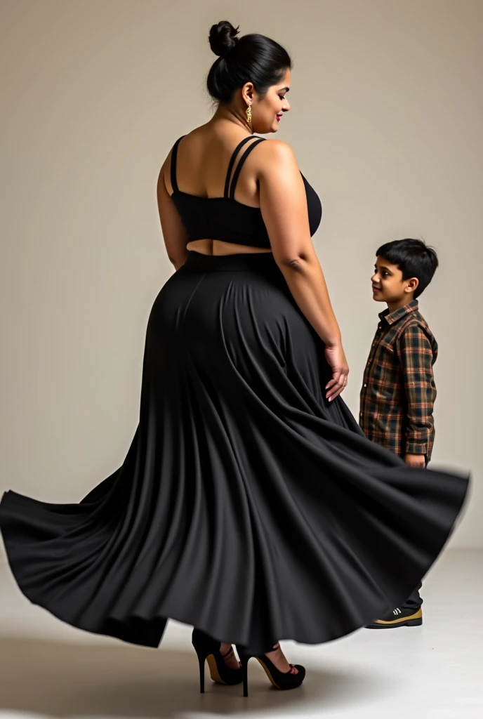 Curvy plus size indian woman wearing a silky black short lehenga and a black sleeveless choli . She is bending forward and swinging her hips . A young school boy is standing behind her and watching her. Womans hair is tied in a bun and she is wearing high ...