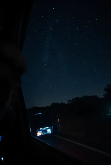 A photo through the window in the car of the night sky