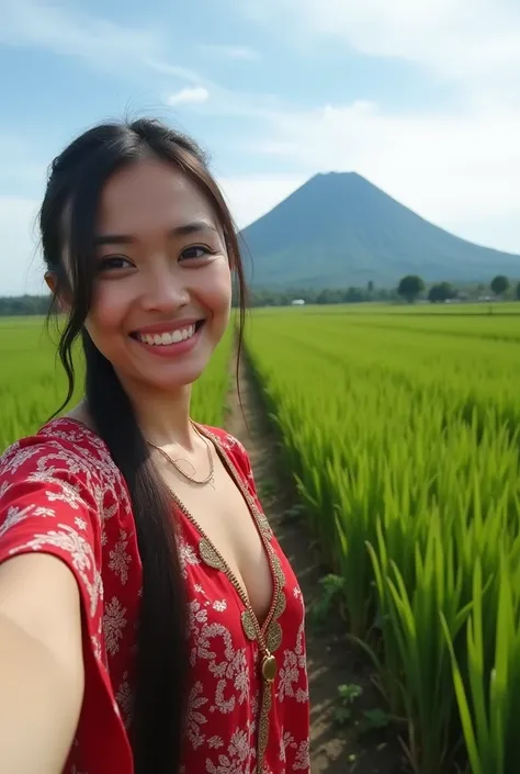  A beautiful young Indonesian woman wearing a traditional kebaya clearly shows her large cleavage..and a young Indonesian man is having a selfie in the middle of a rice field with a beautiful natural view of the archipelago against the backdrop of Merapi m...