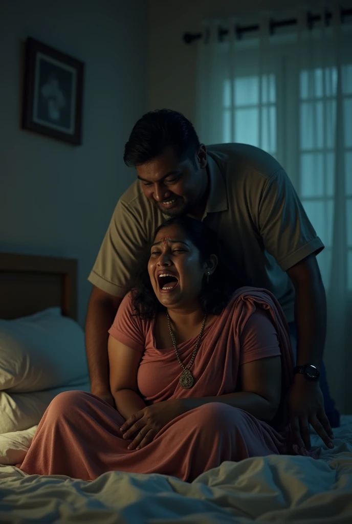 Indian medium plus size mom bends over in bed and cries loudly while her drunken husband is standing behind, pushing her hard from back and smiling with pleasure she is giving to him, at night in the dark room. Full body view.