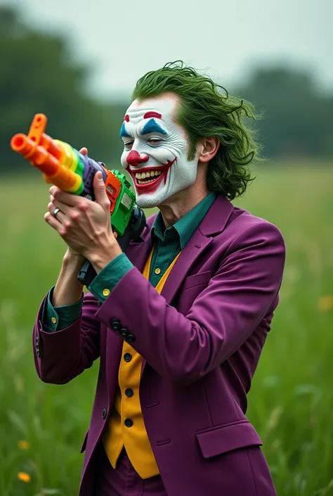 The joker laughing while holding AK-47 colourful toy gun in a grassy field