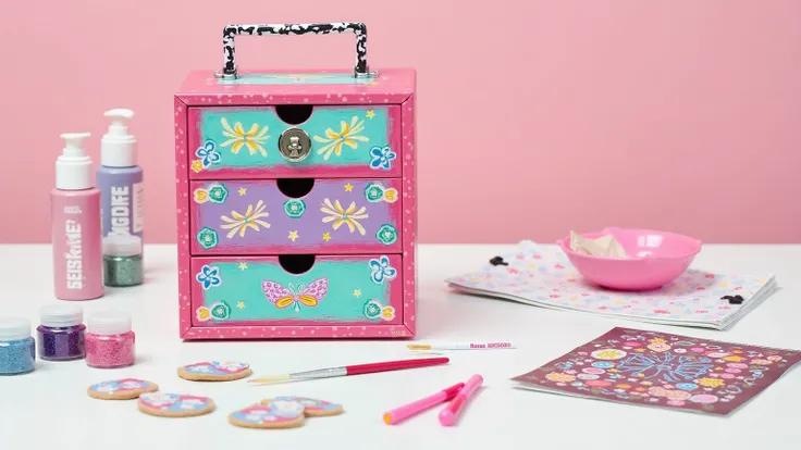 A vibrant display of a DIY customized cosmetic box, featuring painted designs and glitter embellishments. The setting includes DIY tools like paints, brushes, and stickers, placed on a creative workspace to highlight the personalization process and creativ...