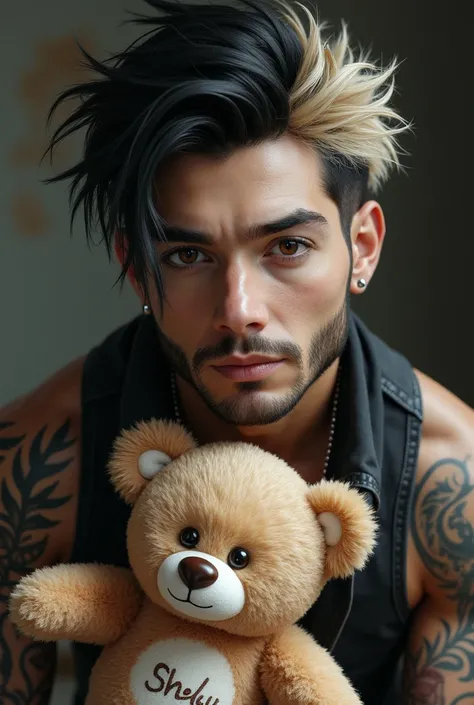 white male, brown eyes, tattoos, sort black and blonde hair has a bear says (Shelly) says on the teddy bear 