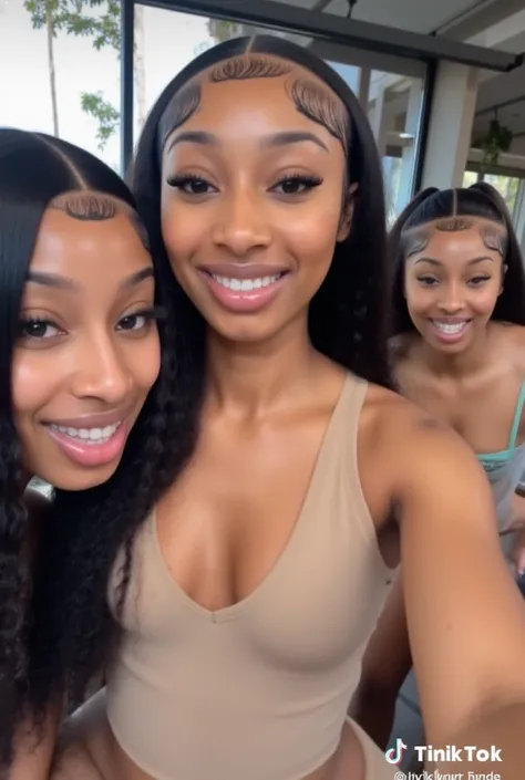 a picture of a slim pretty black girl from Atlanta black baddie girl with a video aesthetic with a nice define chiseled jawline with almond slanted shape eyes and she is at a photo shoot laughing with friend wearing a stylish unique form of micro bikini