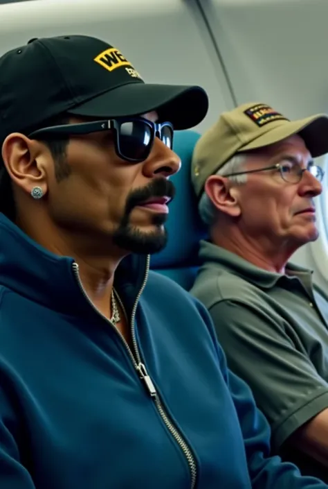 The image shows two men sitting on an airplane. The snoop dog on the left is wearing a blue jacket, a black baseball cap, and sunglasses. He has a mustache and is looking off to the side with a serious expression on his face. On the right is an older man w...