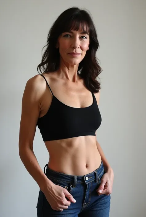 full body shot photograph of a mature woman, 65 years old, slim body, tight jeans, skinny waist, crop top, long dark hair, straight hair with bangs, thigh gap, posing sexy, seductive smile, high detail, best quality, ultra detail, jeans belt, aged skin, sl...