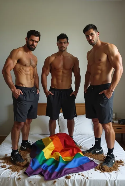 Des jeunes hommes sportifs méditerranéens, en survêtement , les mains dans les poches, en Nike  boueuses, debout sur un lit, piétinent un drapeau LGBT chiffonné et souillé de boue. 