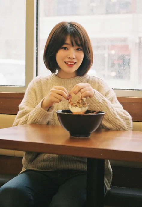 realistic photograph,portrait of japanese woman sitting in ramen restaurant,short bob hair,eyeliner,eyeshadows,blush,burgundy lips,beige sweater,jeans,holding ramen bowl on table,looking at viewer,laughing,Snow is falling outside the window.